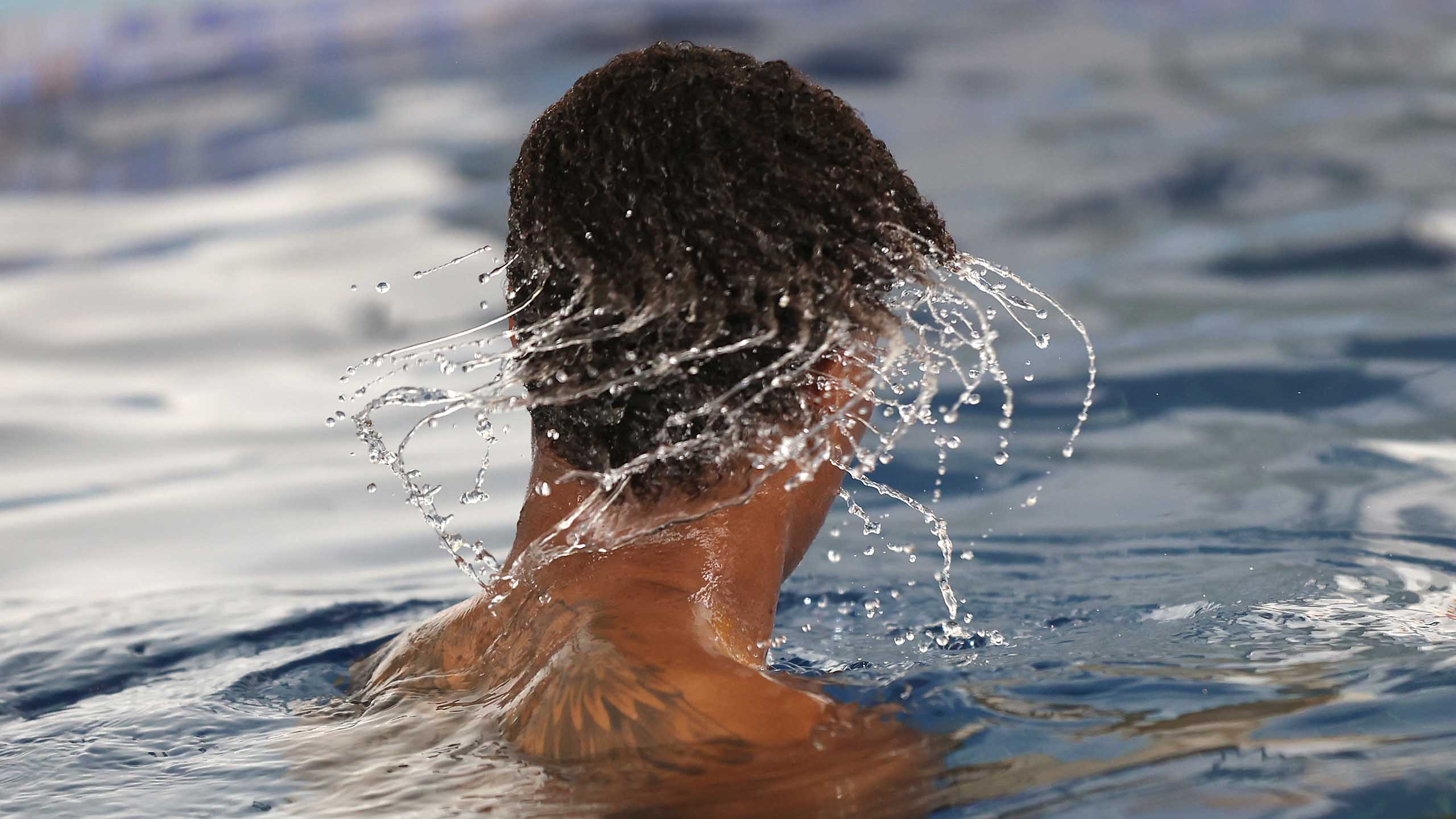 England's Marcus Rashford shakes the water in a pool session at St. George's Park