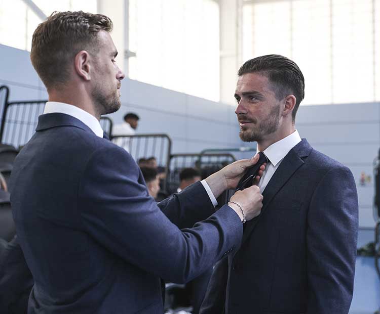England's Jordan Henderson helps Jack Grealish with his tie ahead of EURO 2020
