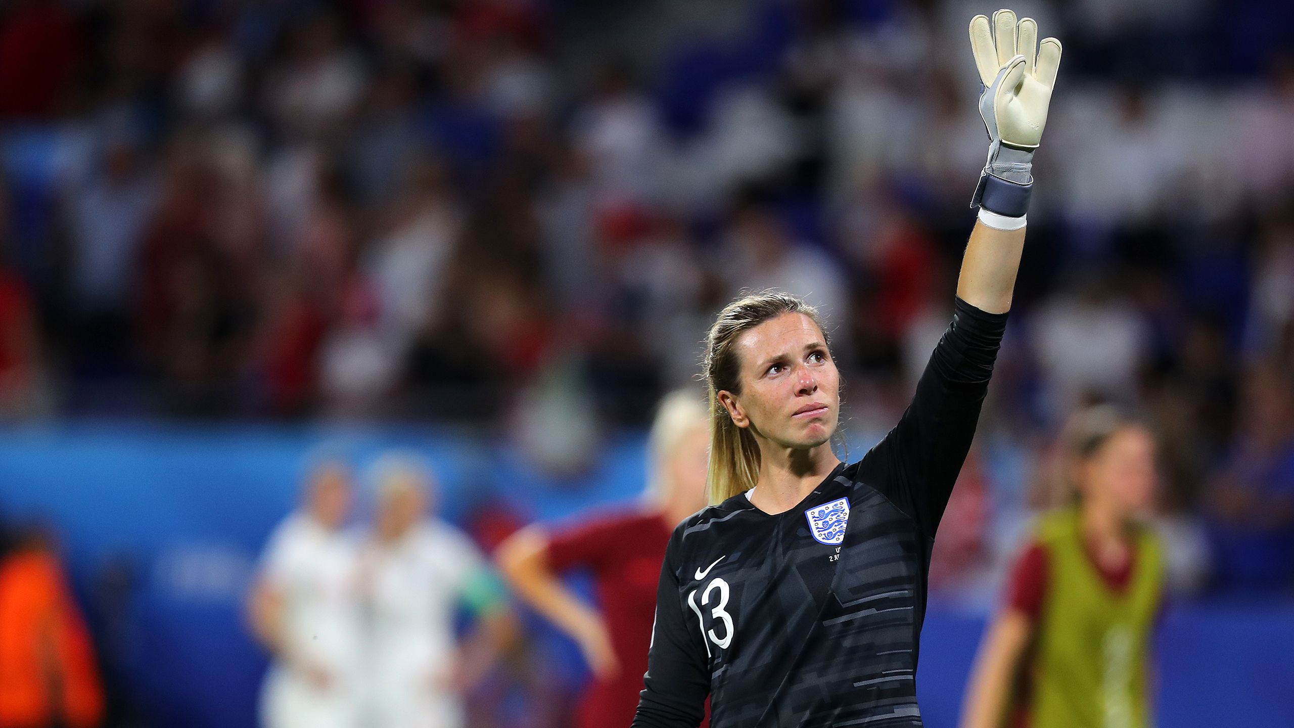 Carly Telford waves at the crowd during a game for England