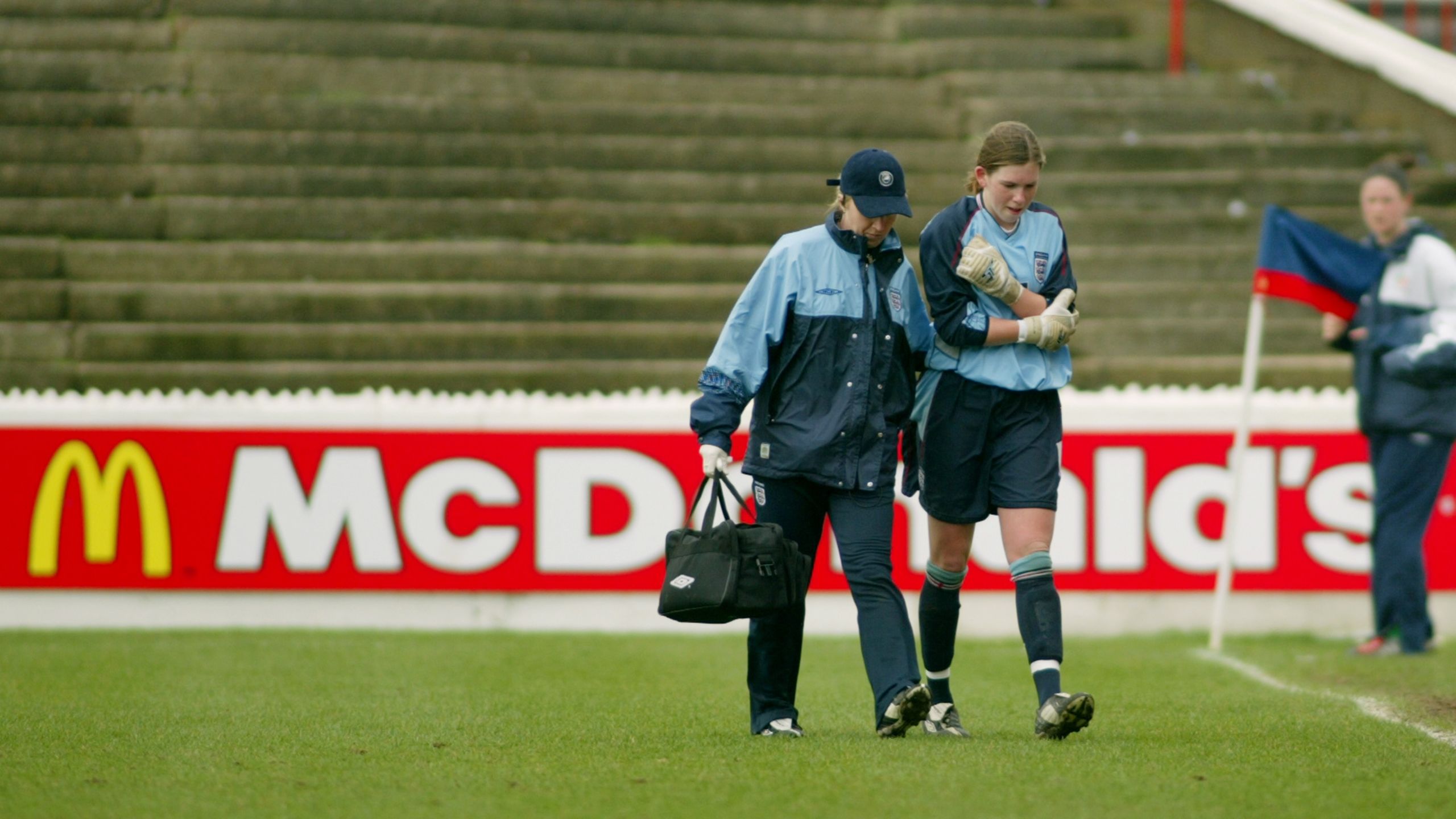 An injured Carly Telford leaves the field for England U19s against Ireland in 2004