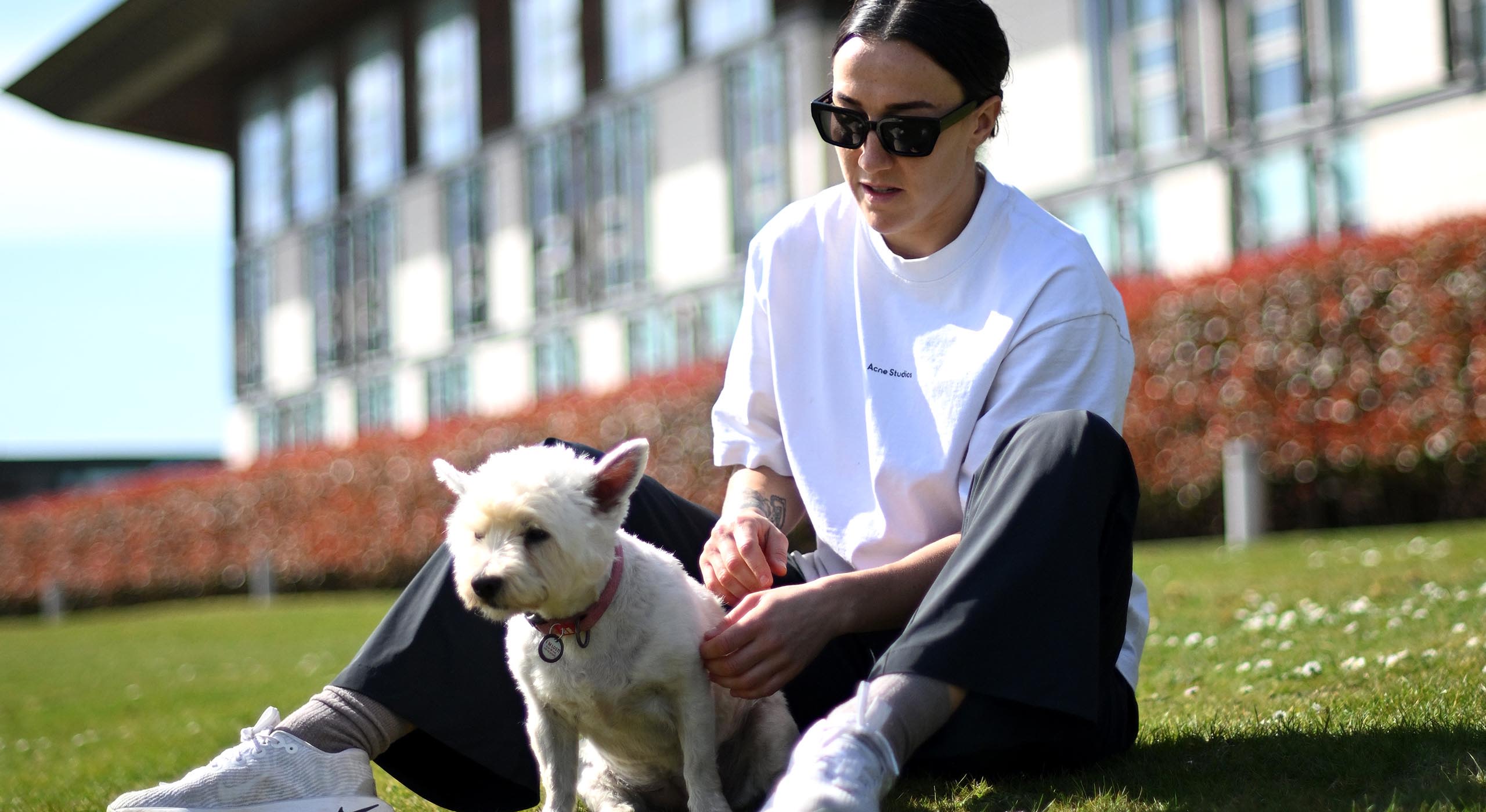 Lucy Bronze of England interacts with her dog Narla during the England Women International Camp at St Georges Park